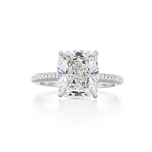 A pave style engagement ring with a platinum knife-edge band and a 3.84 carat cushion cut center stone that is an E color and VS2 clarity according to GIA.