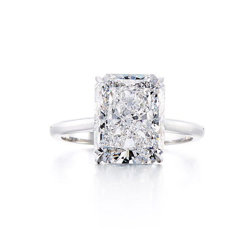 A 5.05 carat cushion cut engagement ring on a platinum solitaire band with a center diamond that is an E color and SI2 clarity according to GIA.