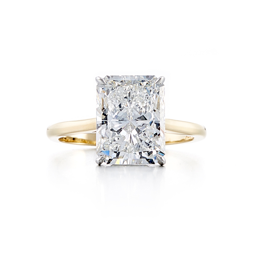 A solitaire style engagement ring with an 18 karat yellow gold band and a 4.01 carat radiant cut center stone that is a G color and VS2 clarity according to GIA.