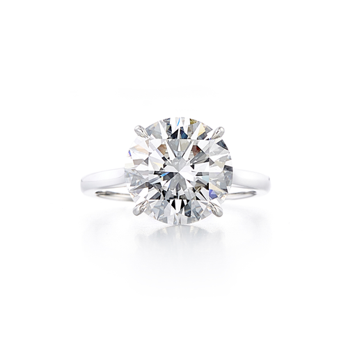 A solitaire style engagement ring with an 18 karat white gold band and a 5.01 carat round cut center stone that is an E color and VS1 clarity according to GIA.